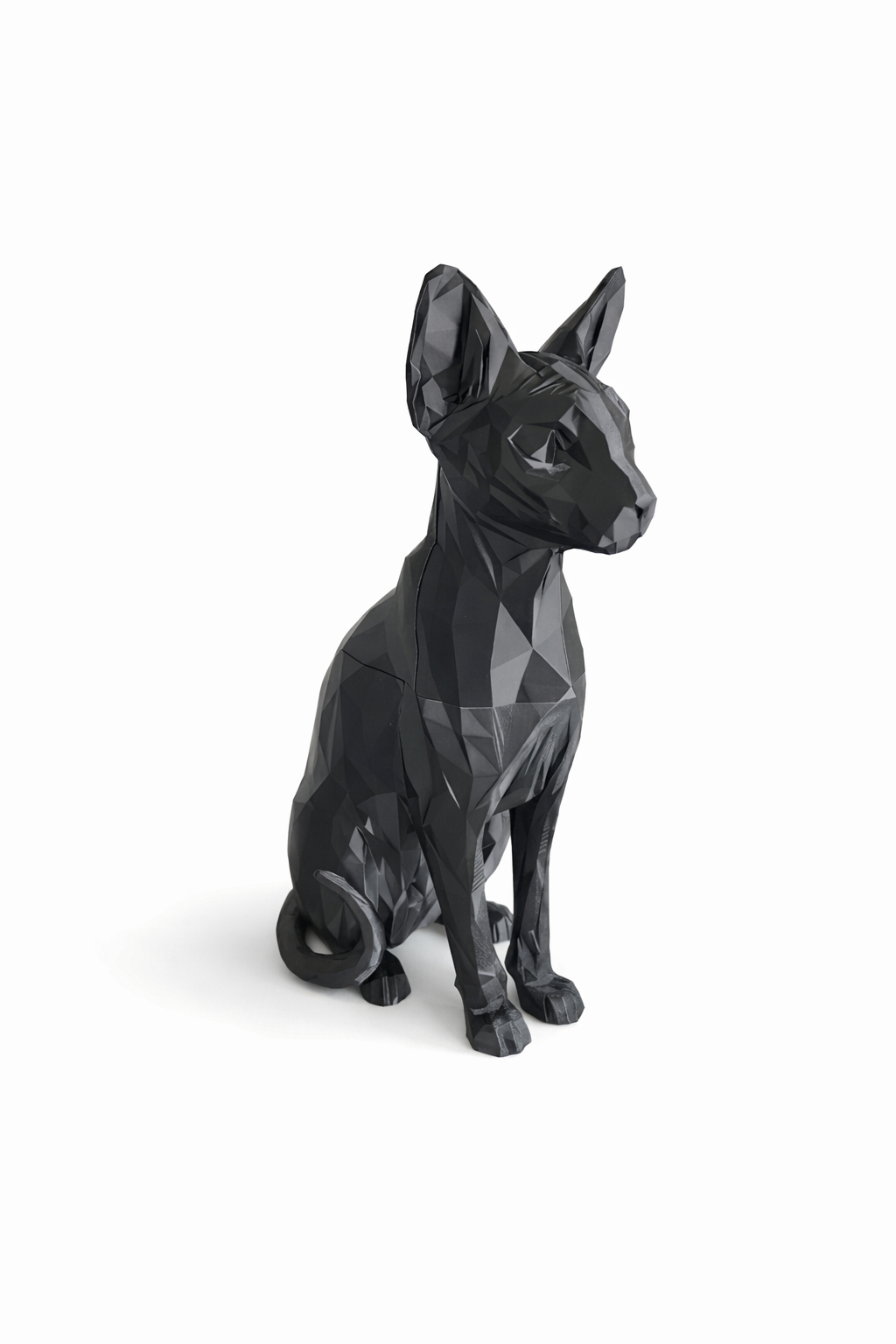 Black geometric dog sculpture on a white background