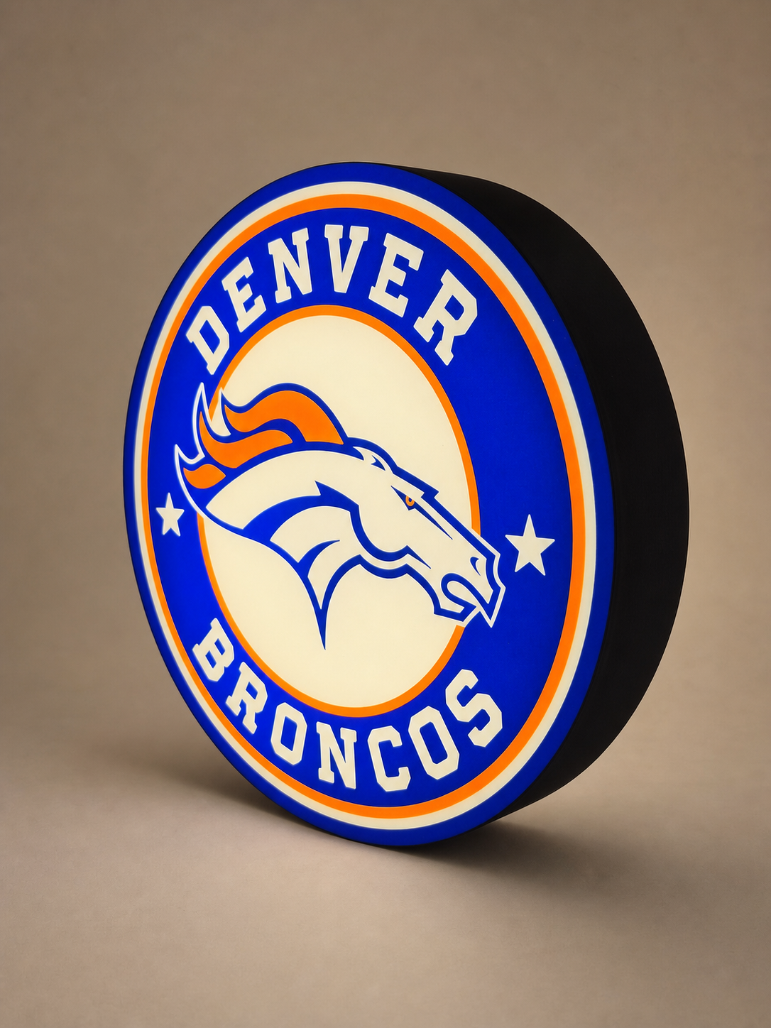 Custom blue and orange round LED lightbox, illuminated, shown at a three-quarter angle on a warm neutral studio background