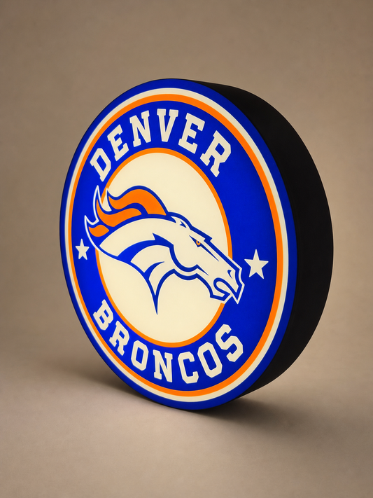 Custom blue and orange round LED lightbox, illuminated, shown at a three-quarter angle on a warm neutral studio background