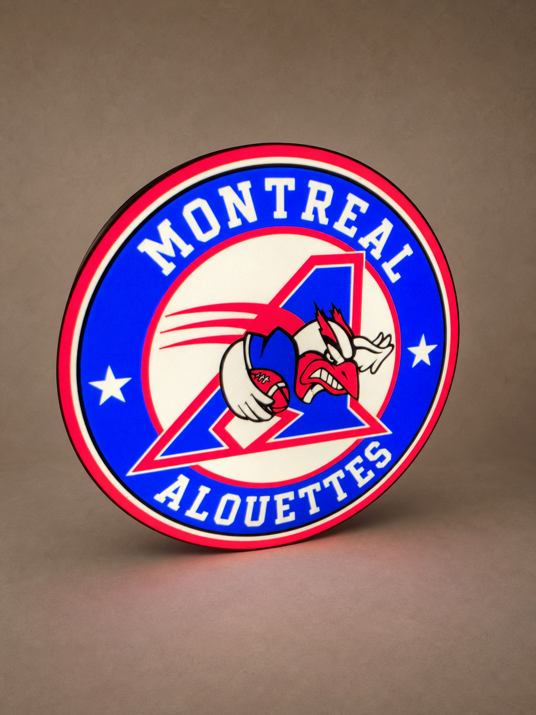 Custom red and blue round LED lightbox, illuminated, on a warm neutral studio background
